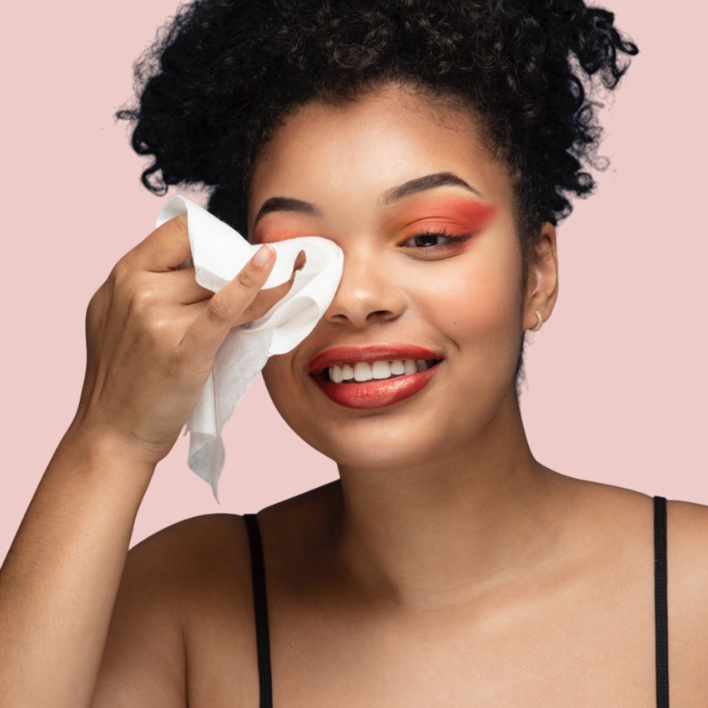 Woman taking off her makeup with a wet wipe